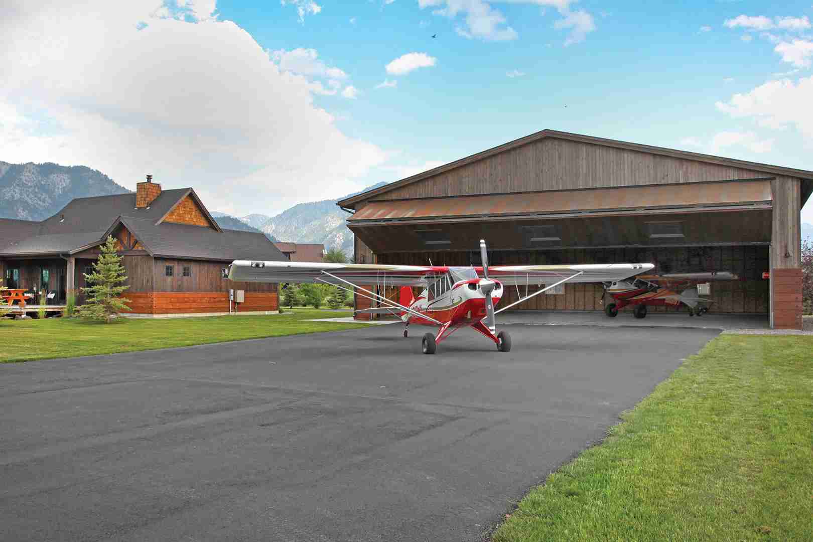 rural hangar plane in front of bifold door