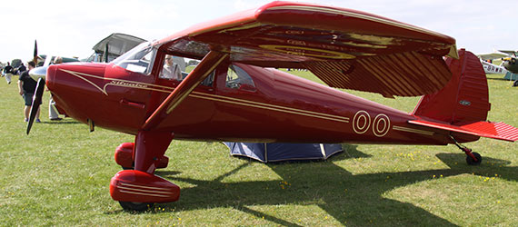 red luscombe plane on the grass
