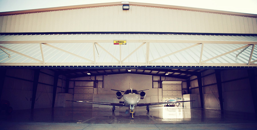 Plane in hangar with hydraulic door, looking in