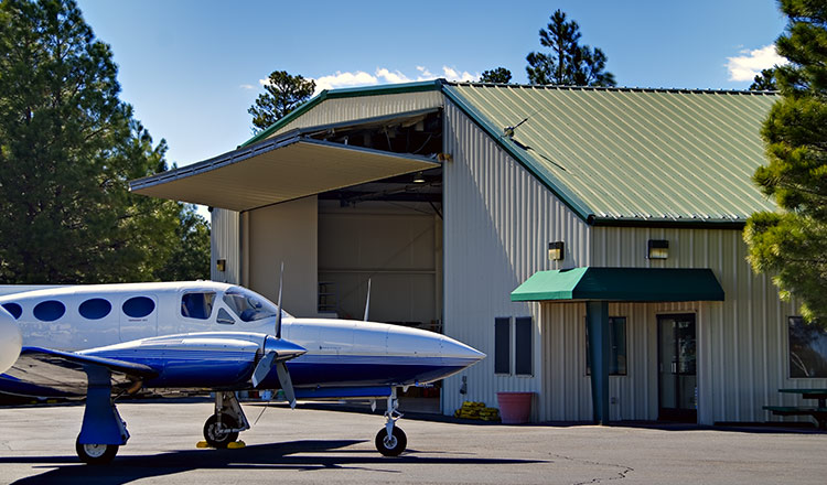 Bifold hangar door with a plane in front
